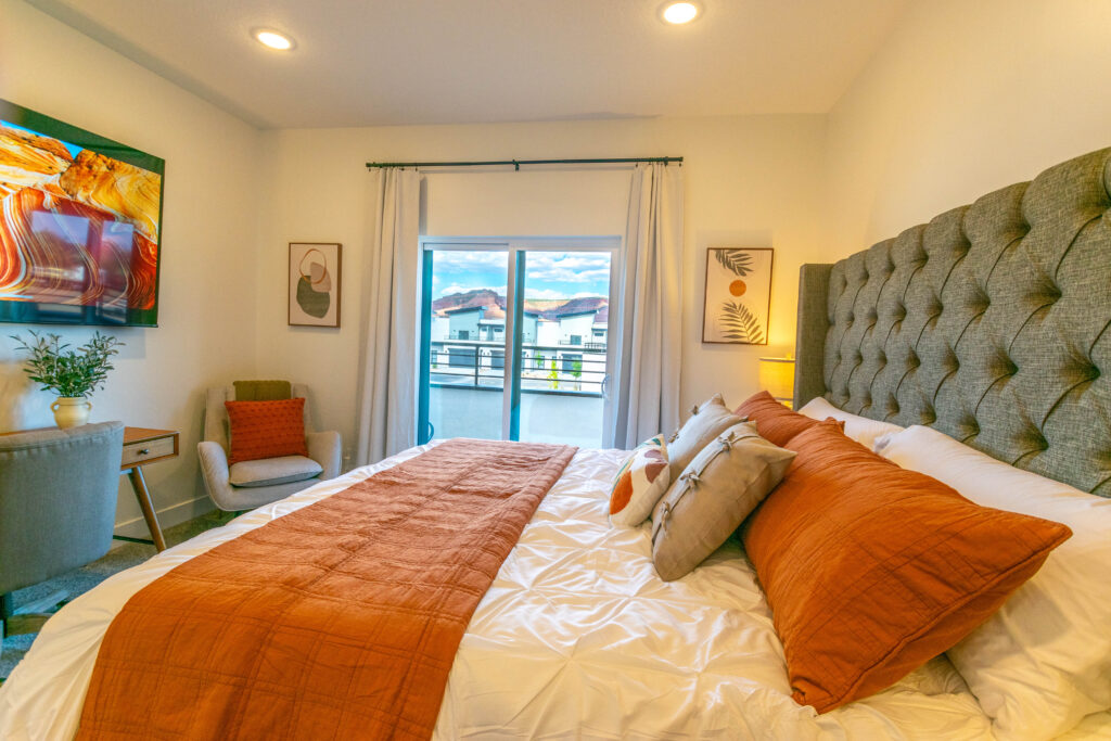 Primary bedroom king bed with sliding door to private balcony