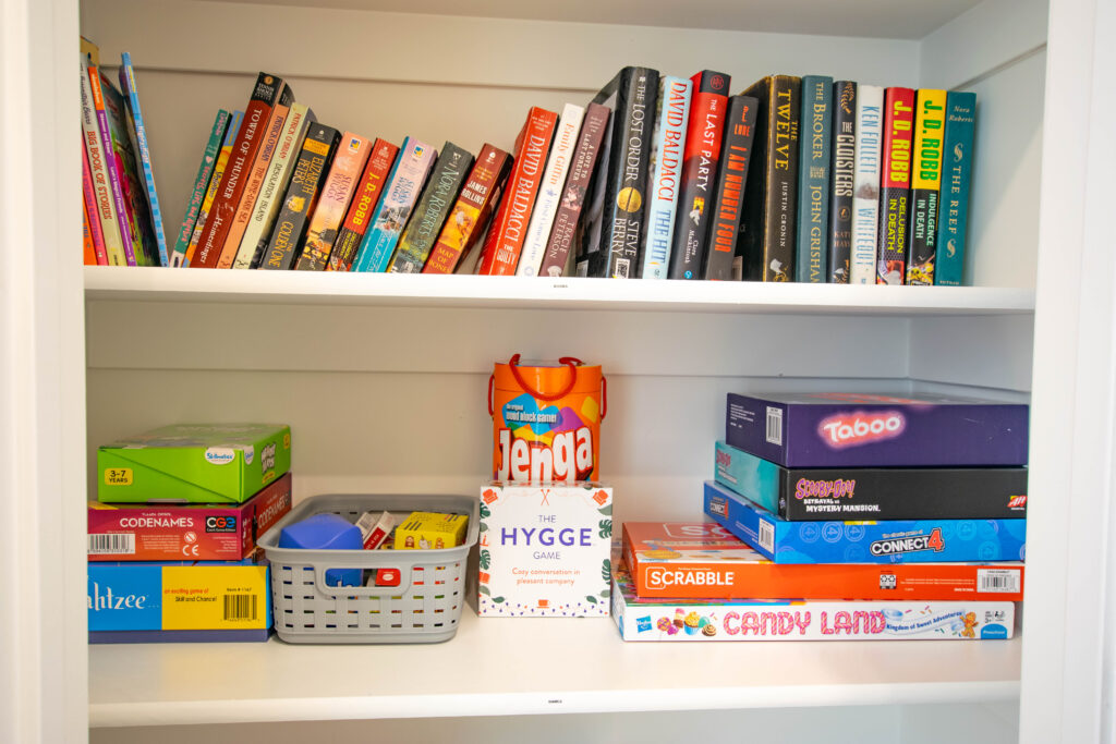 Shelf of books and board games for rainy days