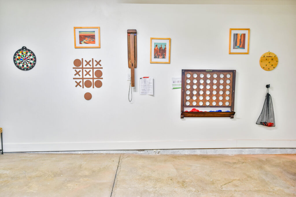 Garage game wall with darts, connect four and ring toss