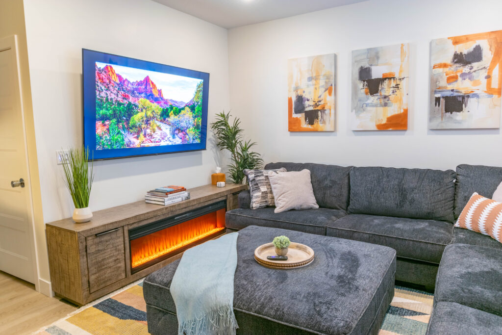 Open living room with electric fireplace and large windows